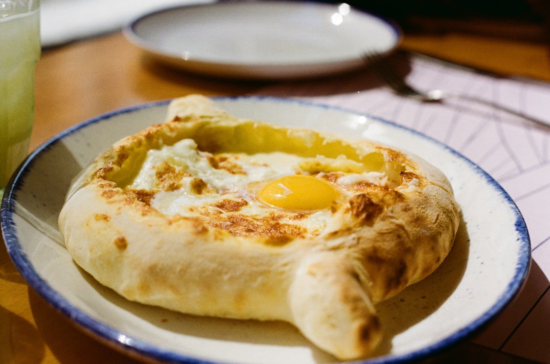 Traditional Georgian khachapuri and khinkali dishes on a table in Tbilisi